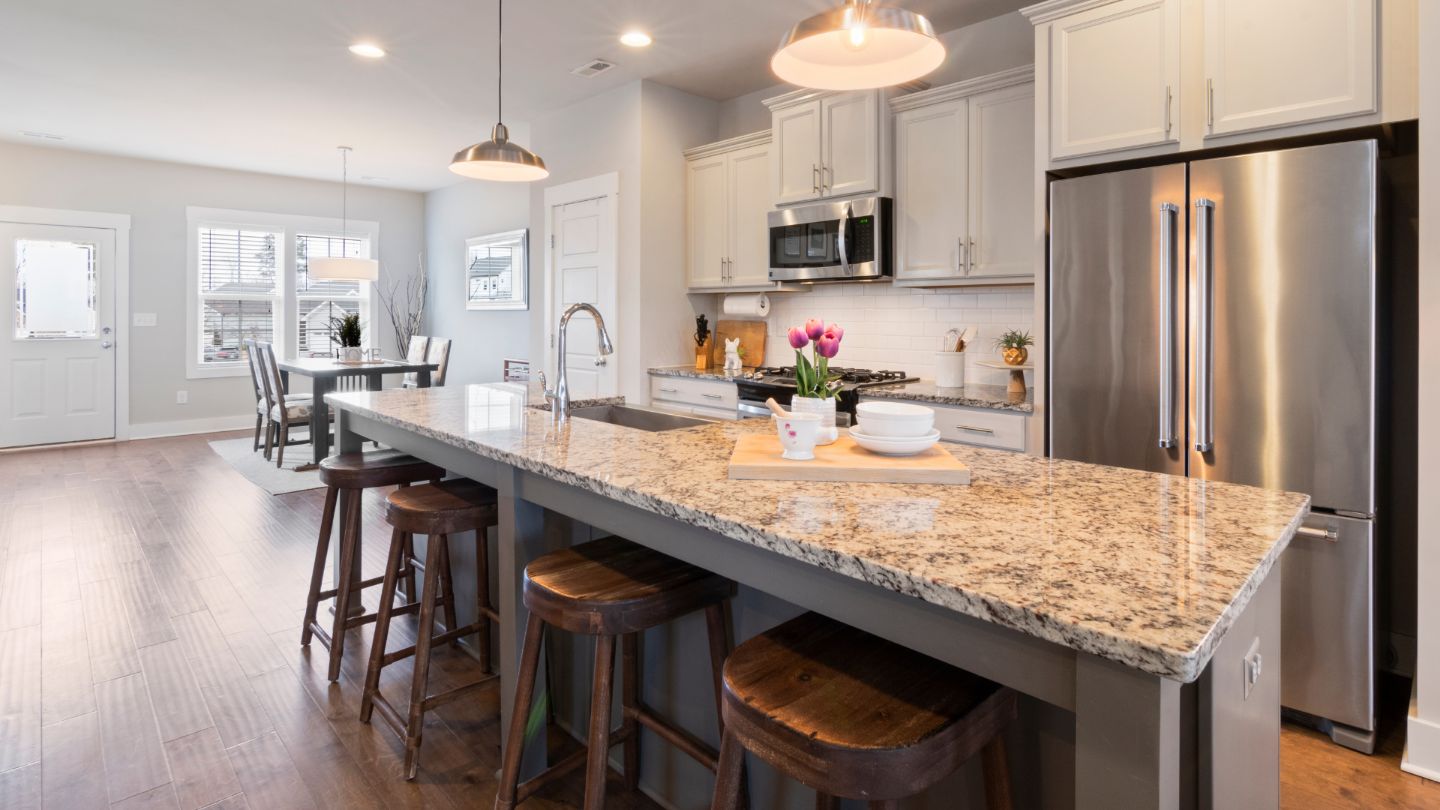 Spotless modern kitchen with granite countertops and stainless steel appliances